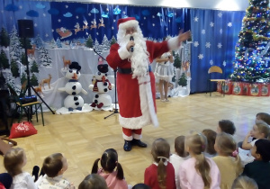 Mikołaj stoi i rozmawia z dziećmi