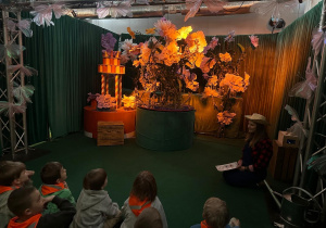 Dzieci siedzą i obserwują co dzieje sie na scenie