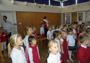 Dzieci stoją i śpiewają